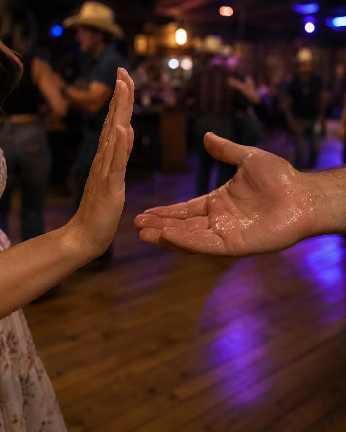 two hands almost touching before a dance